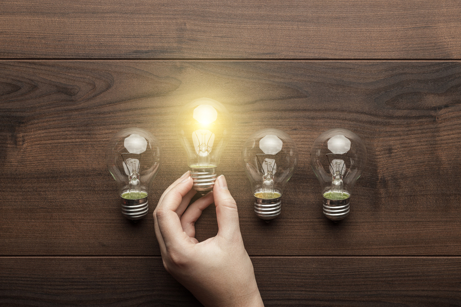Concept of unique genius with a row of light bulbs, one set off and alight